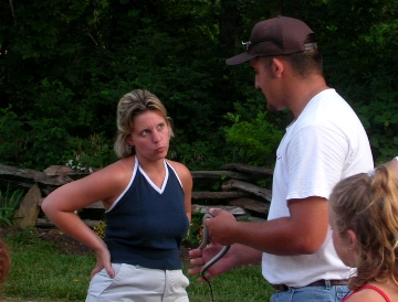 Young Mom apprehensive about touching snake.