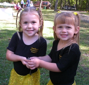 Girls holding snake.